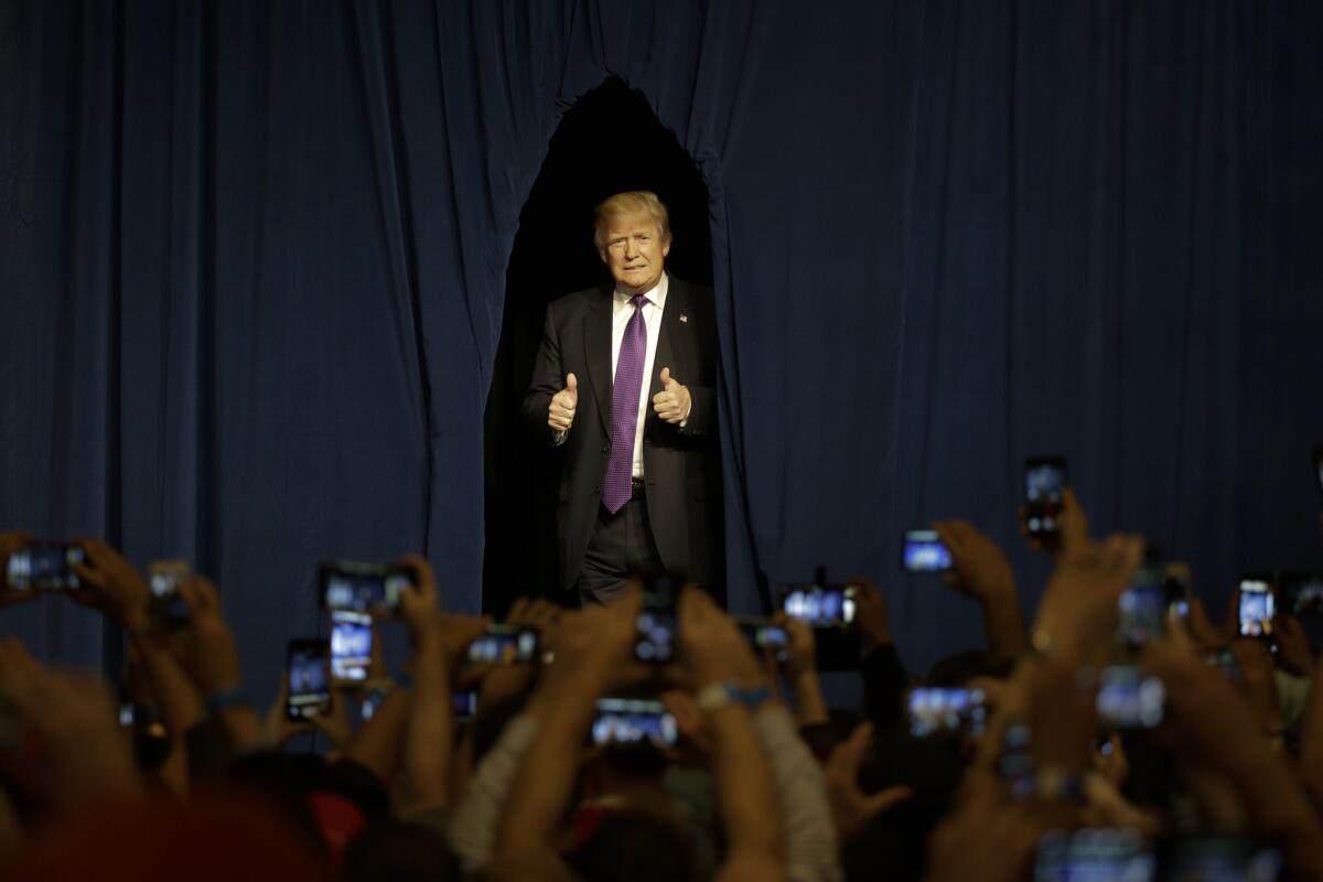 Republican presidential candidate Donald Trump arrives for a caucus night rally Tuesday in Las Vegas.