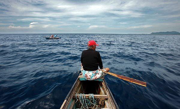 Johnny Aralaji, leader of a Badjao community in Puerto Princesa, Philippines, scans the sea for almost nonexistent schools of fish. The Badjao, an ancient seafaring community with origins in the Sulu Sea, are known locally as sea gypsies or the Bedouin of the sea.