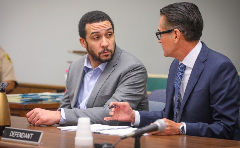 Former NFL player Kellen Winslow II talks to his defense attorney Marc Carlos.