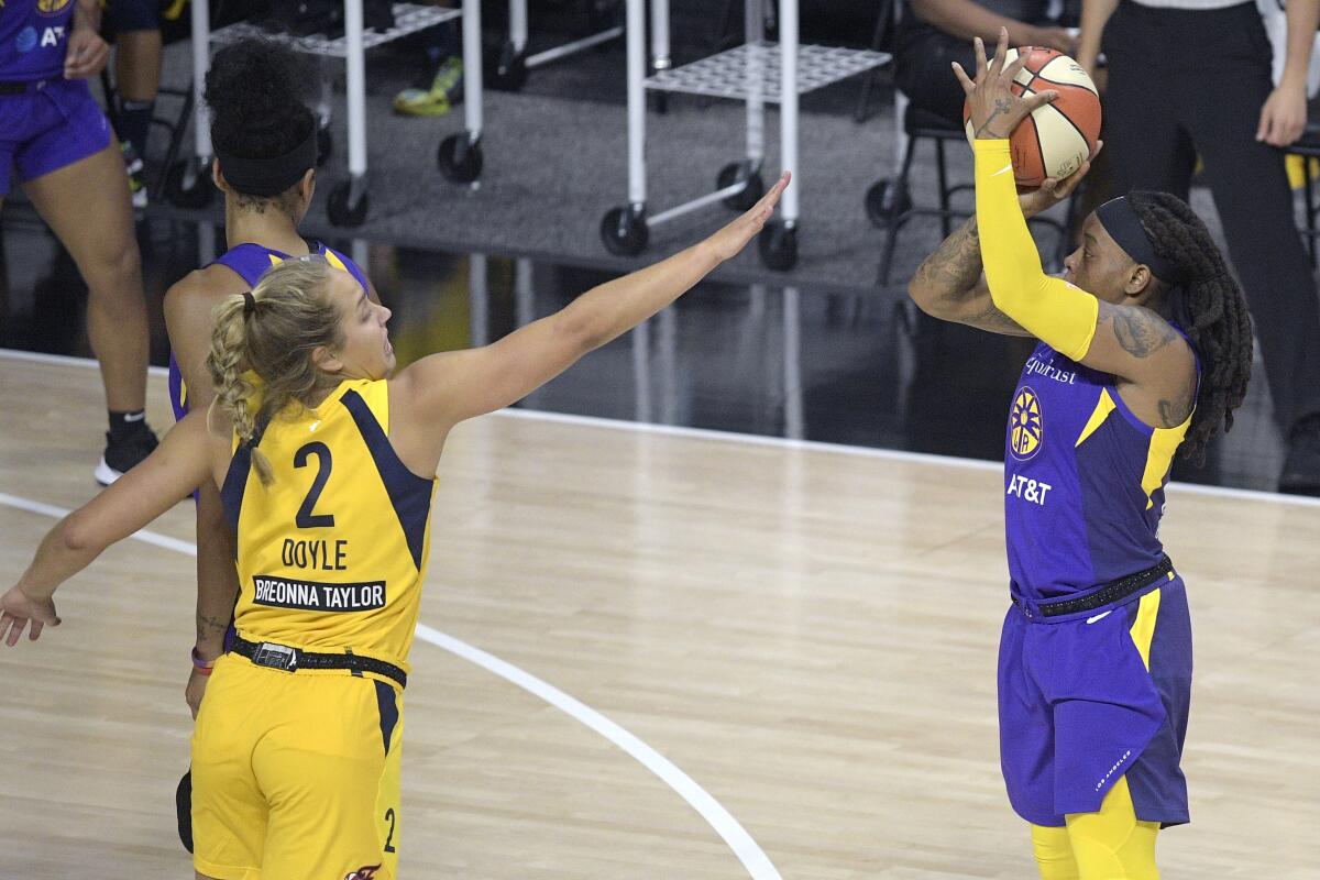 Sparks guard Riquna Williams goes up for a shot in front of Indiana Fever guard Kathleen Doyle.