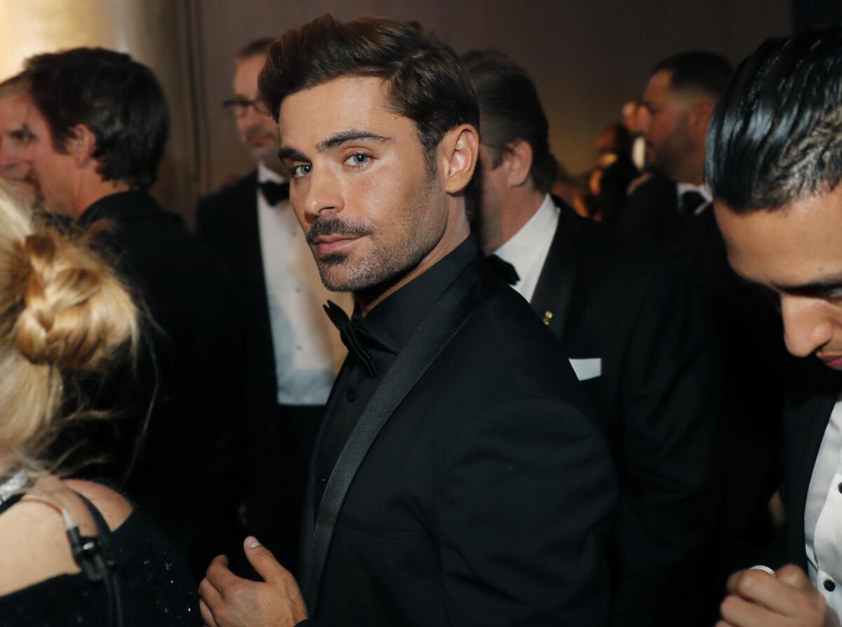 Actor Zac Efron in a black suit