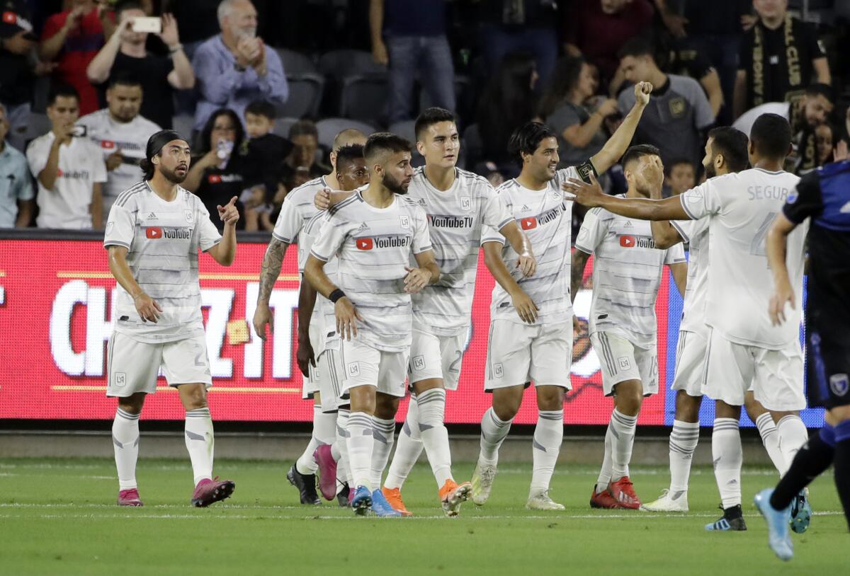 LAFC forward Carlos Vela, with arm raised, celebrates with teammates after scoring on a penalty kick against the San Jose Earthquakes during the first half on Wednesday in San Jose.