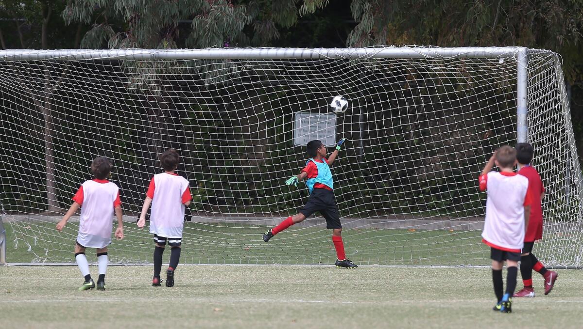 Adams Elementary's Joseth Zarate shot sails into the net for a goal in a boys' fifth- and sixth-grade Silver Division pool-play match against Kaiser at the Daily Pilot Cup on Friday at Jack R. Hammett Sports Complex in Costa Mesa.