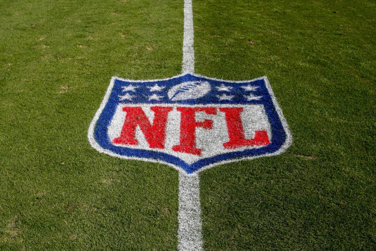 NFL logo painted on grass.