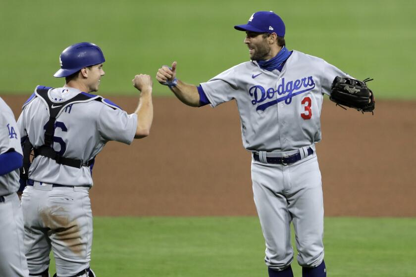 Los Angeles Dodgers left fielder Chris Taylor (3) celebrates with catcher Will Smith.