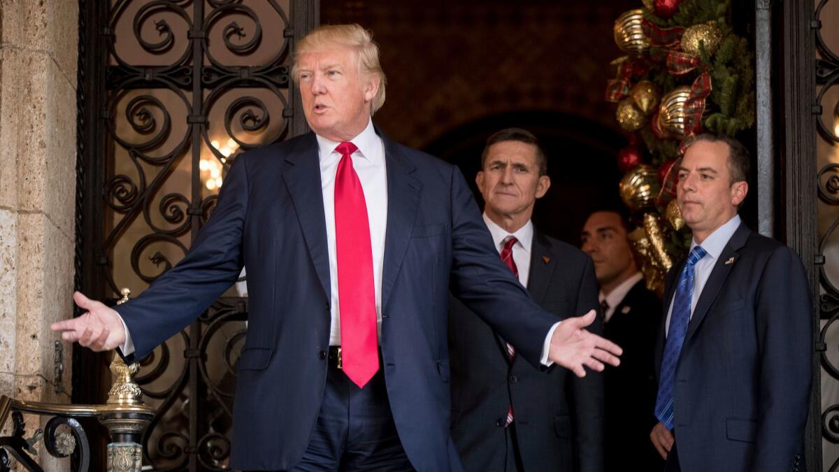 President-elect Donald Trump accompanied by his Chief of Staff Reince Priebus, right, and Retired Gen. Michael Flynn, a senior adviser to Trump, center, at Mar-a-Lago in Palm Beach, Fla. on Dec. 21.