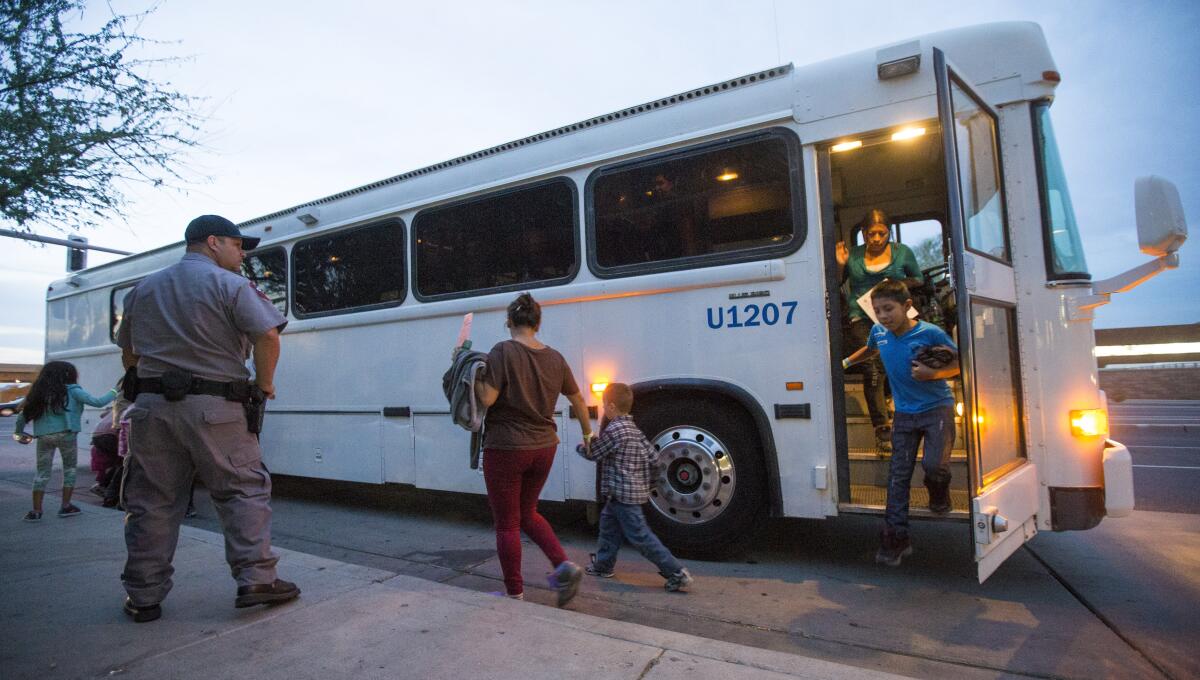 In this May 28, 2014, file photo, migrants are released from ICE custody at a Greyhound bus station in Phoenix. Greyhound, the nation's largest bus company, says it will stop allowing Border Patrol agents without a warrant to board its buses to conduct routine immigration checks. The company announced the change Friday, Feb. 21, 2020, one week after The Associated Press reported on a leaked Border Patrol memo confirming that agents can't board private buses without the consent of the bus company.