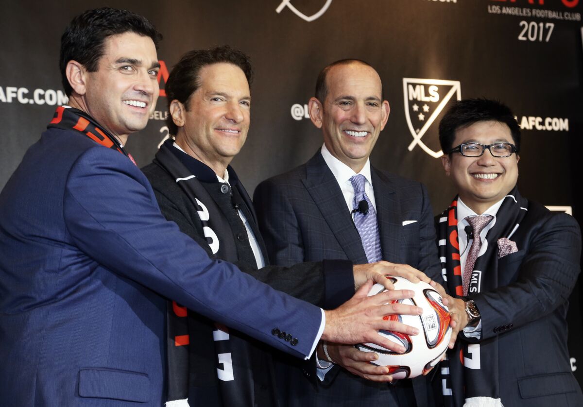 MLS Commissioner Dan Garber, second from right, joins (from left) team owners Tom Penn, Peter Guber and Henry Nguyen to announce the Los Angeles Football Club will join the league in 2017.