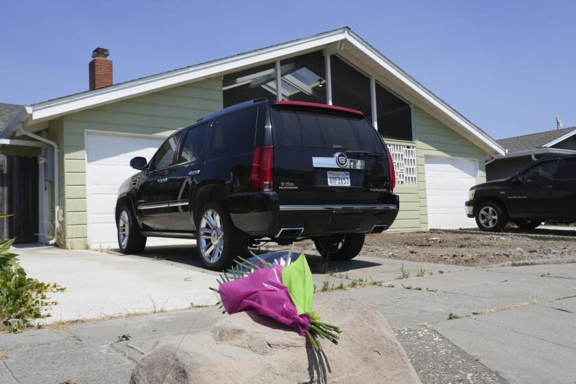 Flowers are seen in front of a home at a residence on Kitty Hawk Road in the City of Alameda, Calif. on Thursday, July 11, 2024. A California man is in custody after fatally shooting his wife, their 6-year-old son and his wife's parents, a San Francisco Bay Area police department said Thursday. (AP Photo/Terry Chea)