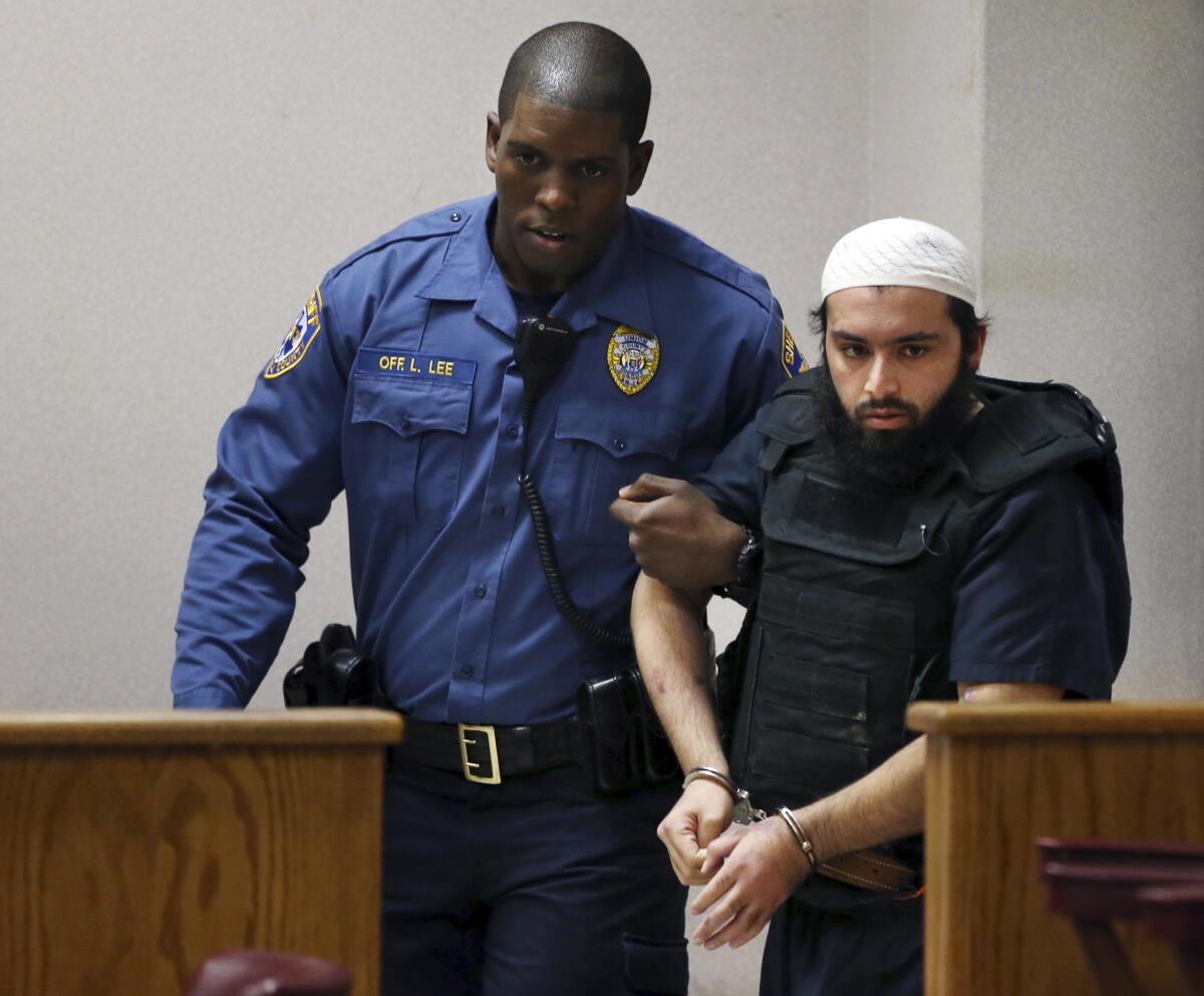 Ahmad Khan Rahimi, the man accused of setting off bombs in New Jersey and New York in September, is led into court Tuesday.