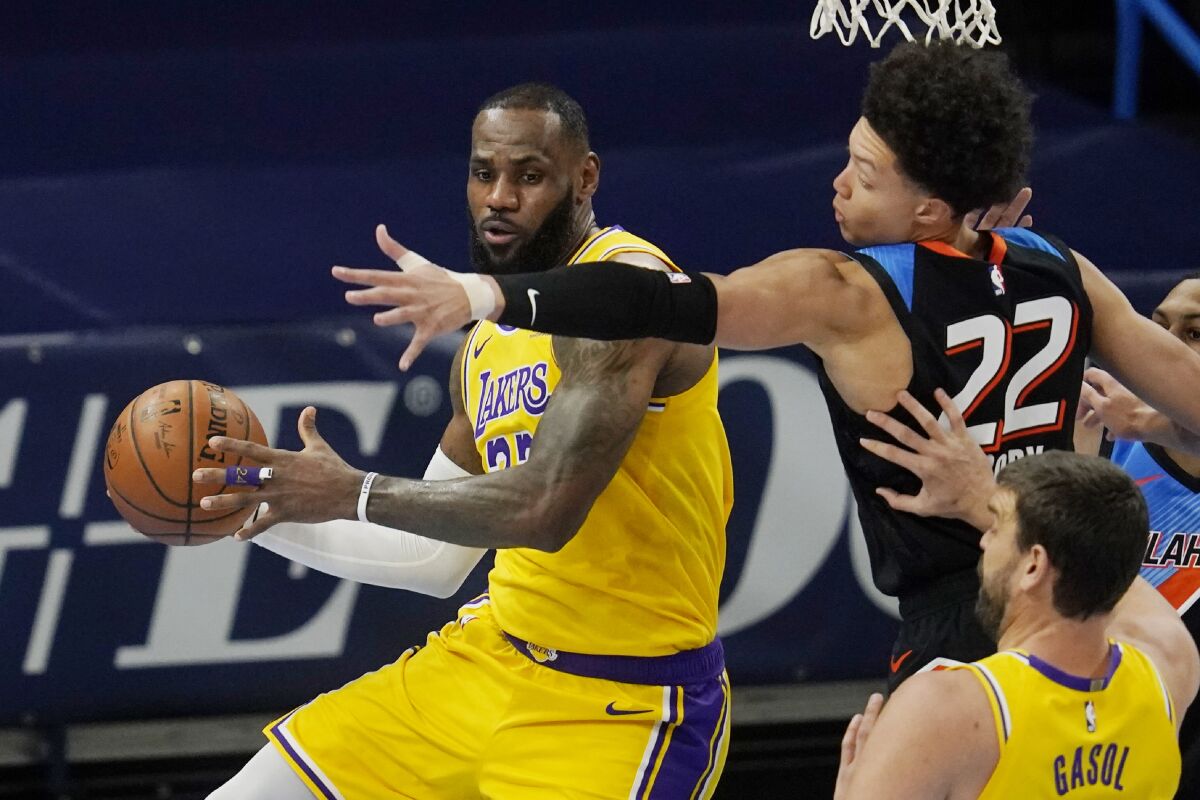 Lakers forward LeBron James moves around Oklahoma City Thunder forward Isaiah Roby.
