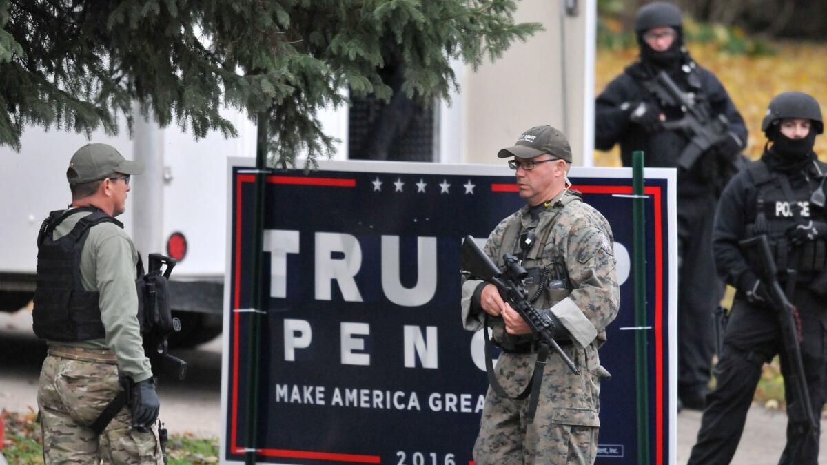 Officers stand guard outside the home of suspect Scott Michael Greene.