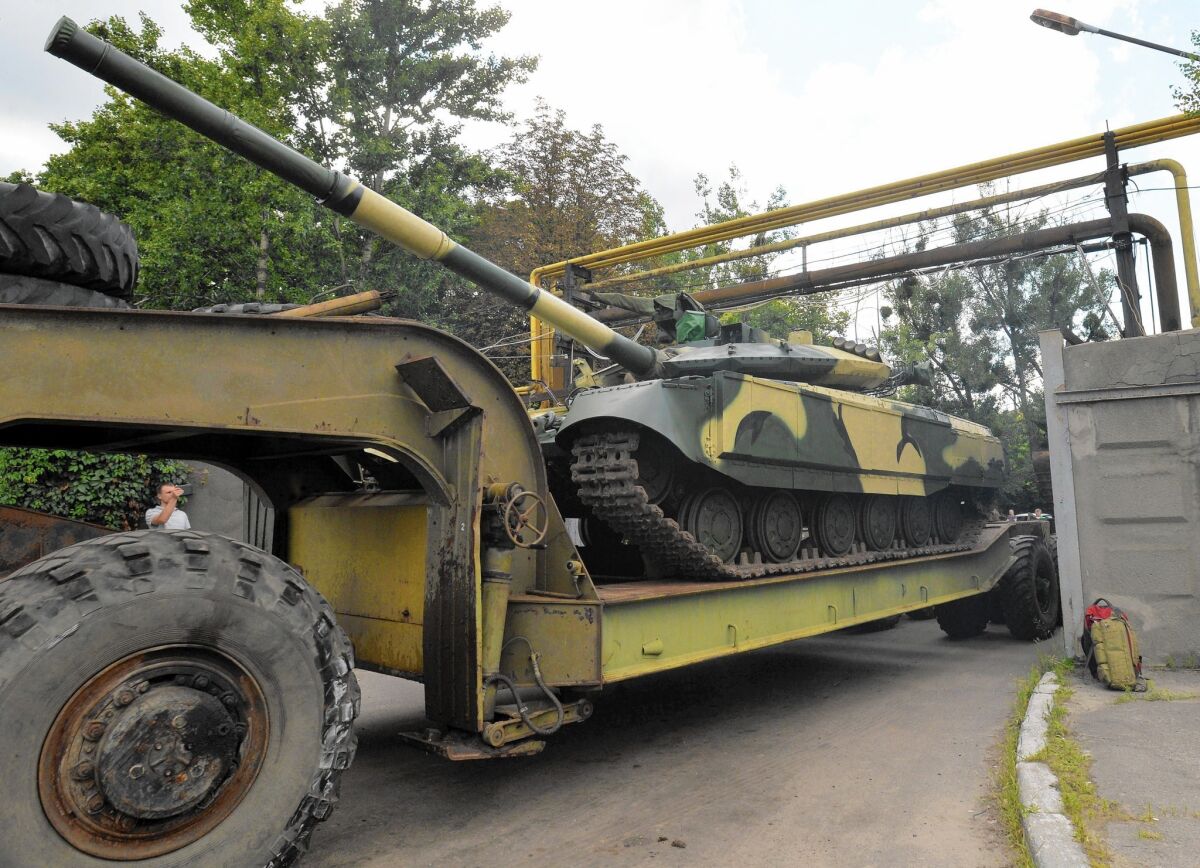 A truck carries a newly made Ukrainian tank from a factory in Kharkiv, in the country's northeast. Ukraine faces a dilemma in keeping its military exports out of Russian hands while preserving a major employment base.
