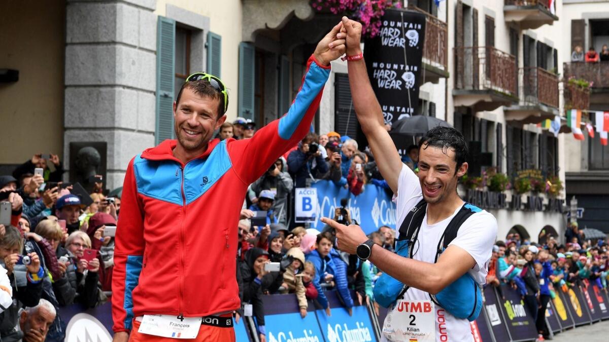 Winner Francois D'Haene of France and second-place finisher Kilian Jornet of Spain, right, celebrate after crossing the finish line of the Mount Blanc Ultra Trail.