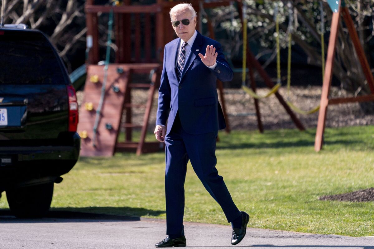 need this moment with you President Biden, in a blue suit and sunglasses, waves.