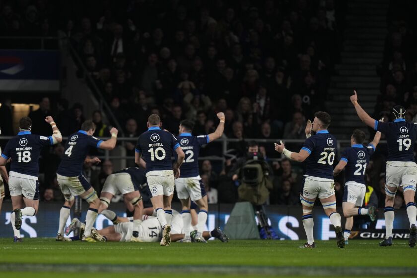 Scotland players celebrate after Duhan van der Merwe scored a try during the Six Nations rugby union international match between England and Scotland at Twickenham in London, England, Saturday, Feb. 4, 2023. (AP Photo/Alastair Grant)