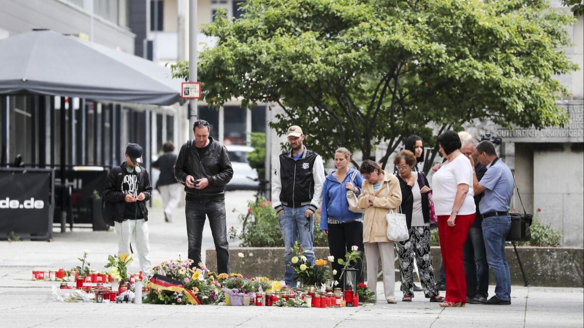 People visit a street memorial in Chemnitz in eastern Germany’s Saxony state on Aug. 28, 2018, where a 35-year-old man was stabbed to death.