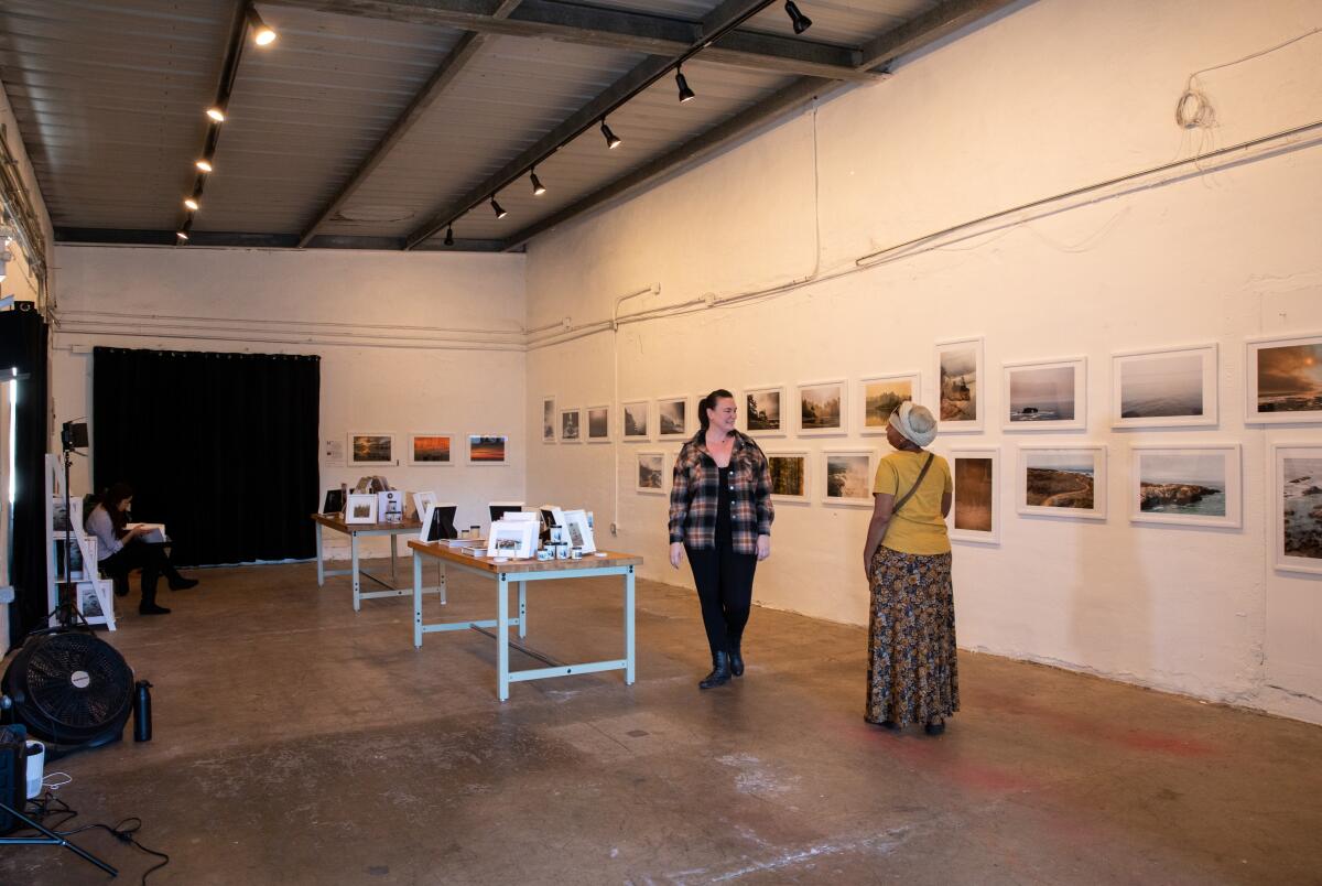 Allison Davis, left, shows her photography to visual artist Ami Young at 1835 Studios in Sherman Heights.