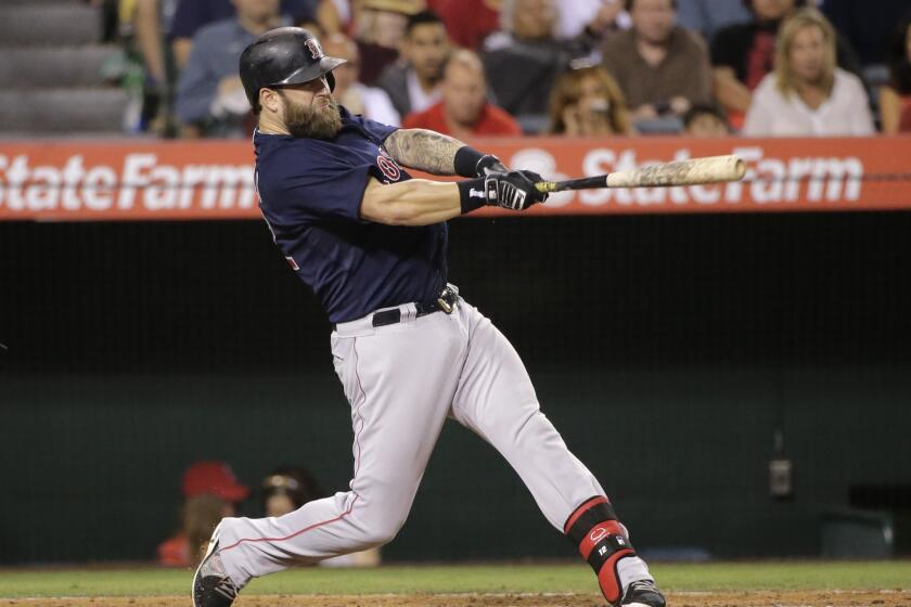 Boston's Mike Napoli hits a home run during the fifth inning of the Angels' 4-2 loss Friday to the Red Sox at Angel Stadium.