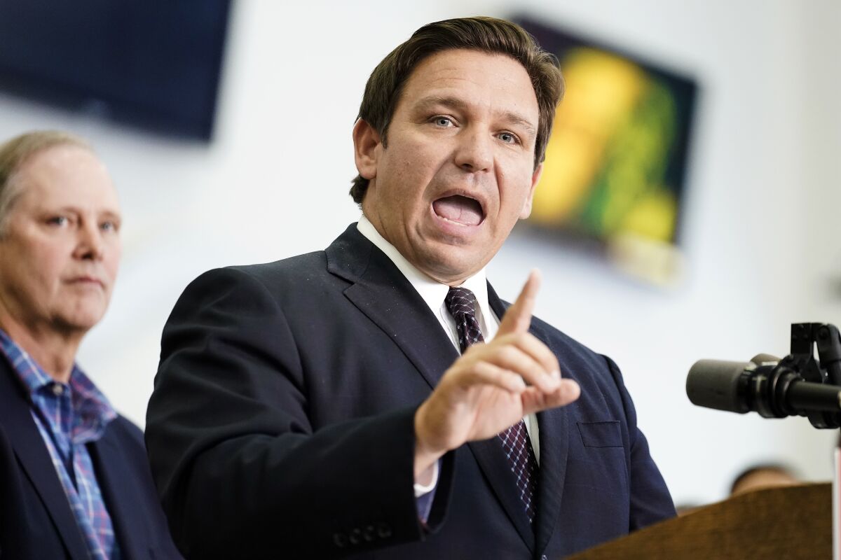 FILE - Florida Gov. Ron DeSantis speaks to supporters and members of the media after a bill signing on Nov. 18, 2021, in Brandon, Fla. In Florida, for the first time in modern history, there are more registered Republican voters than Democrats. Republican Gov. Ron DeSantis is heading into a reelection campaign buoyed by a national profile and a cash reserve unmatched by any of his Democratic challengers. And Republicans control virtually all of state government. (AP Photo/Chris O'Meara, File)