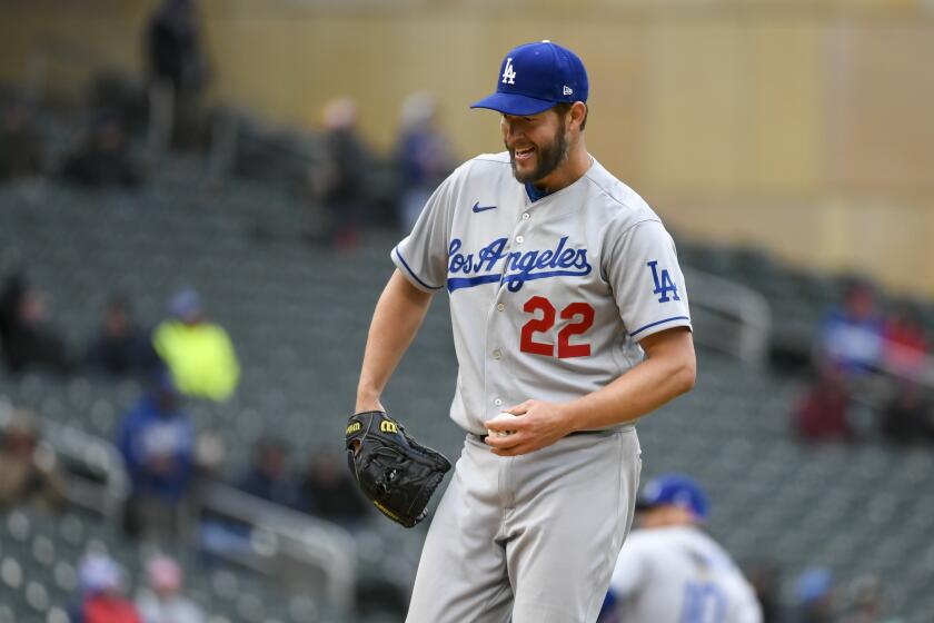 Los Angeles Dodgers pitcher Clayton Kershaw reacts after striking out Minnesota Twins 'Gilberto Celestino during the sixth inning of a baseball game, Wednesday, April 13, 2022, in Minneapolis. Kershaw took a perfect game through seven innings in his season debut, dominating the Minnesota Twins with 13 strikeouts in 21 batters.(AP Photo/Craig Lassig)