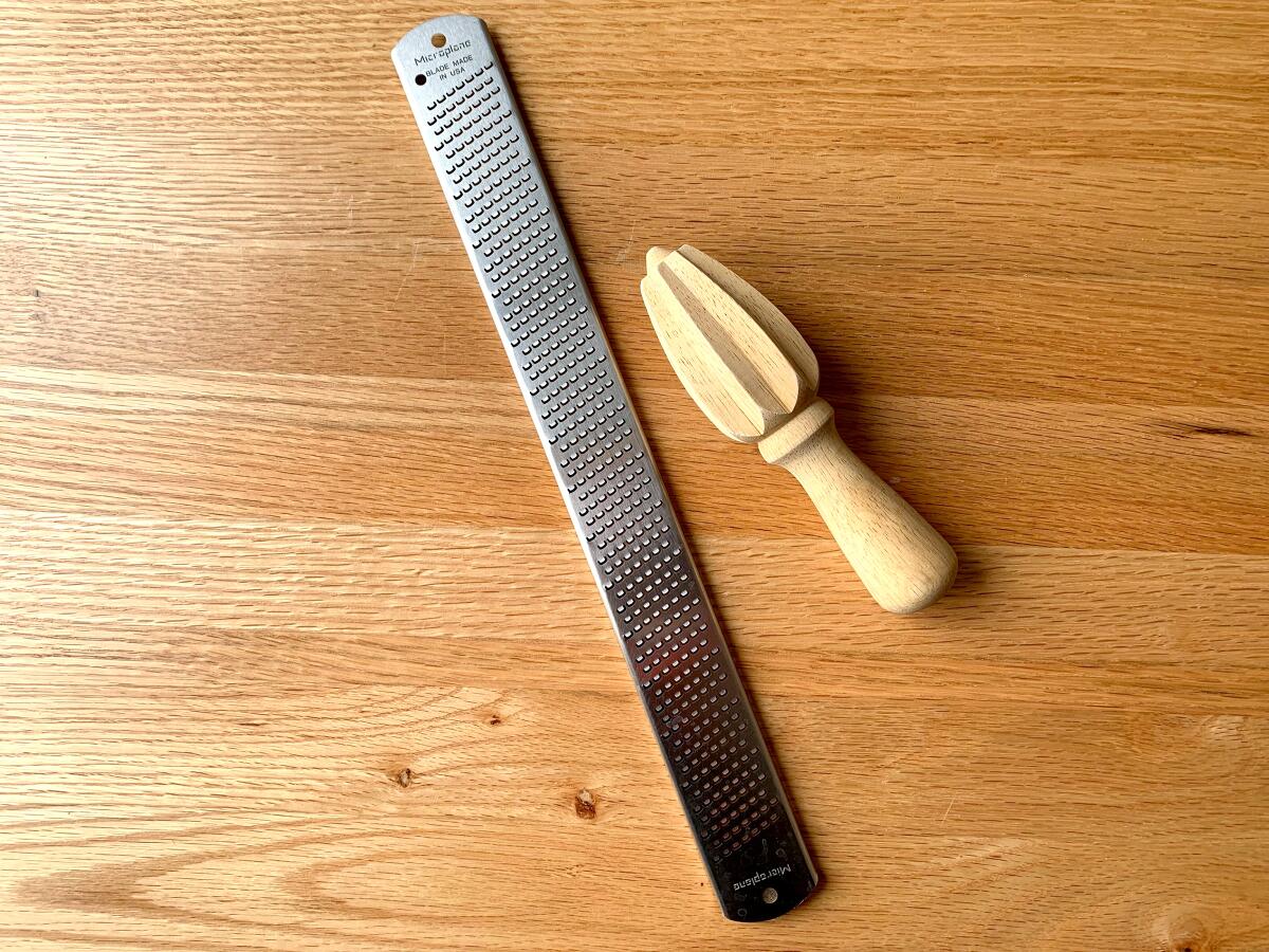 A Microplane brand grater and citrus reamer.