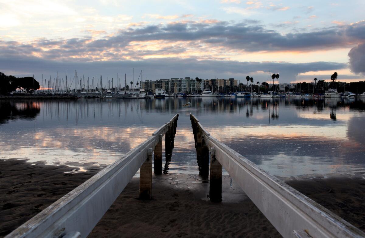 The sun rises over Mother's Beach in Marina del Rey in 2010.