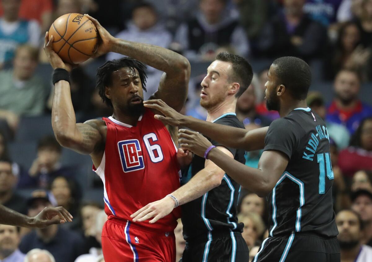 Clippers big man DeAndre Jordan tries to keep the ball away from Hornets teammates Frank Kaminsky III and Michael Kidd-Gilchrist during a game on Feb. 11.