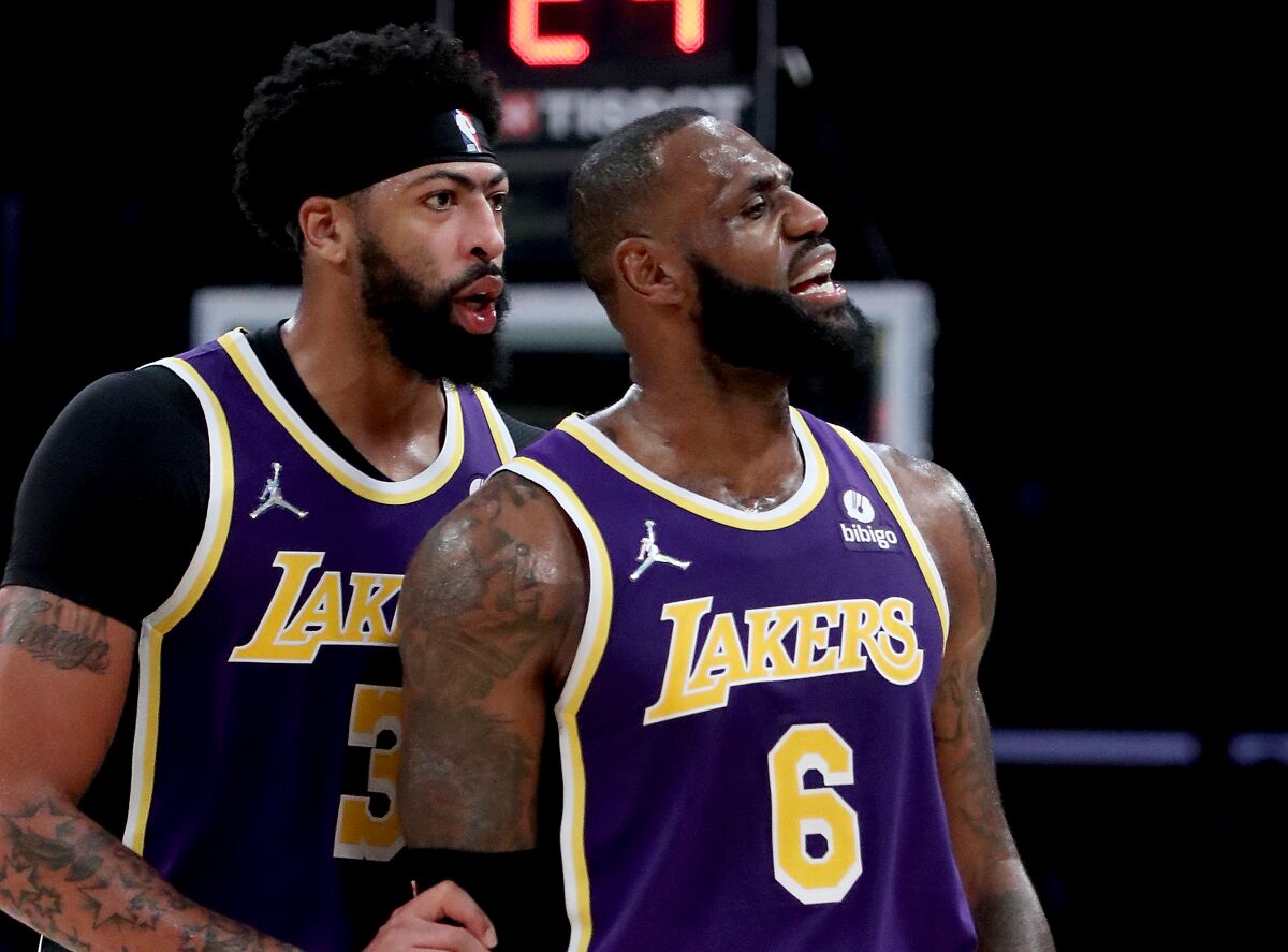 Lakers forward Anthony Davis talks to teammate LeBron James during the fourth quarter.