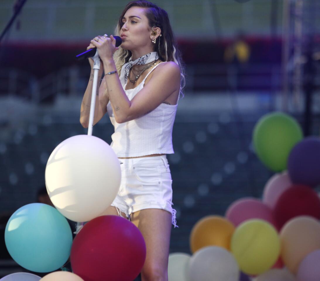 Miley Cyrus performs in the middle of a stage full of balloons during the Wango Tango concert.