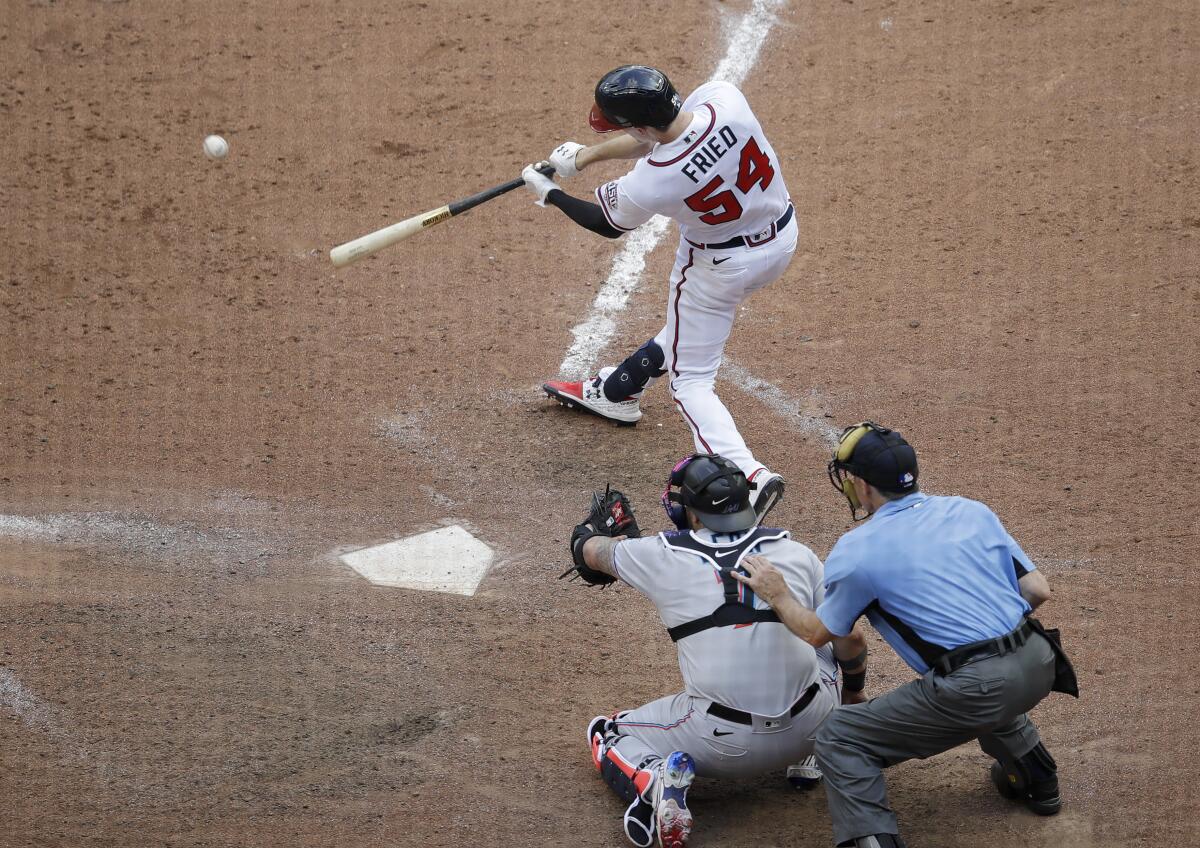 Atlanta Braves' Max Fried swings for the winning hit against the Miami Marlins during the 10th inning of a baseball game Sunday, July 4, 2021, in Atlanta. (AP Photo/Ben Margot)