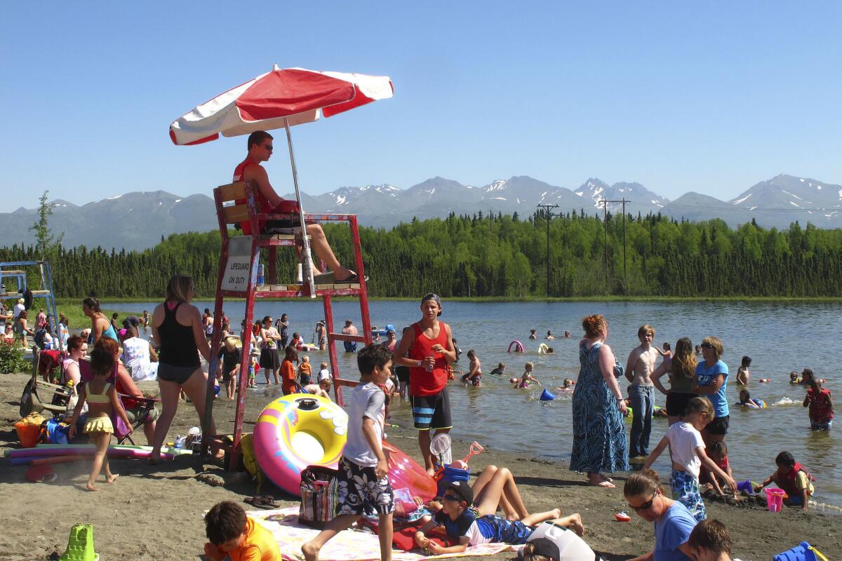 Alaskans enjoy the sun and water at Goose Lake in Anchorage this week.