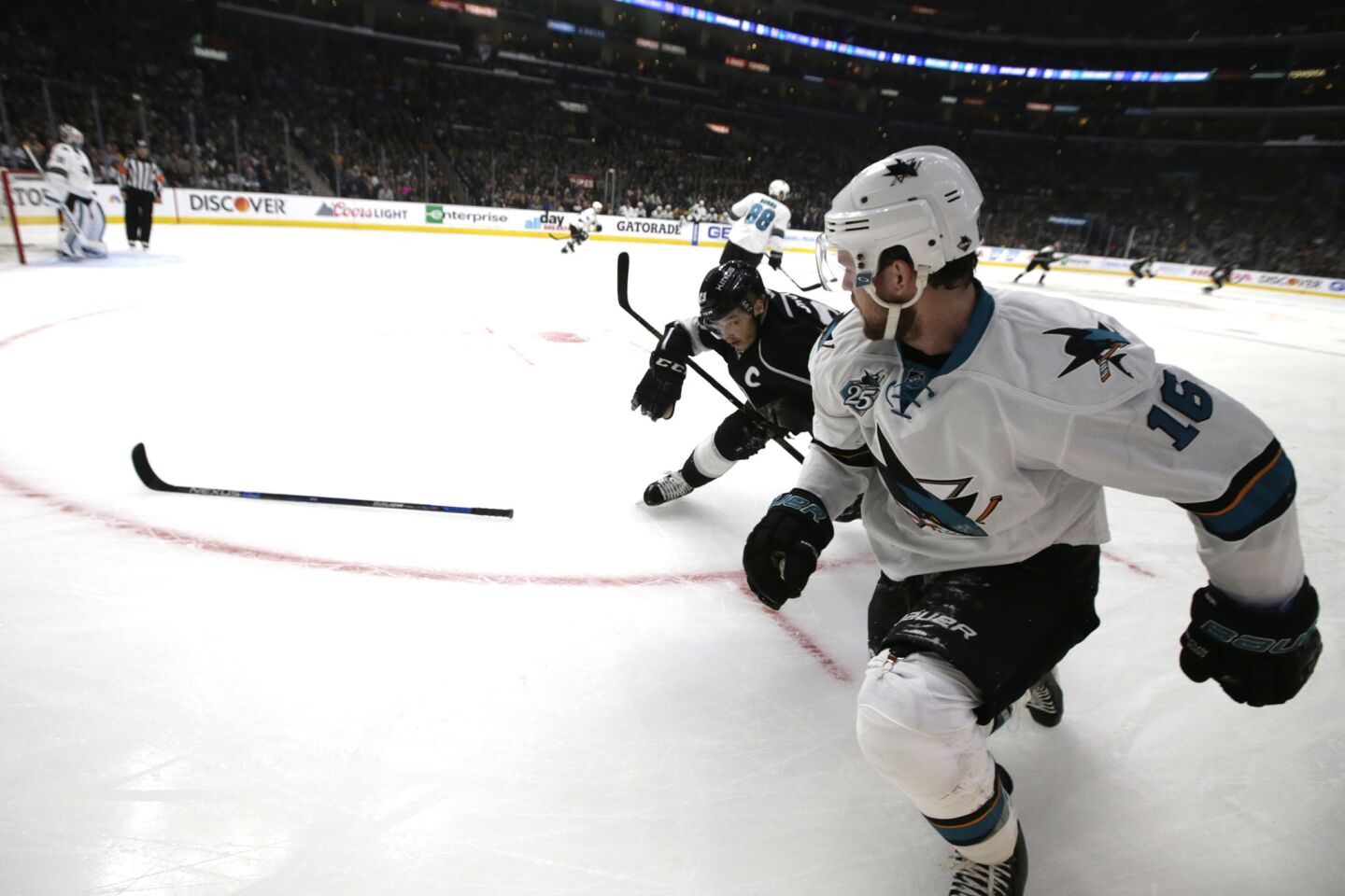Kings forward Dustin Brown knocks the stick away from Sharks forward Nick Spaling during the first period of a game on April 22.