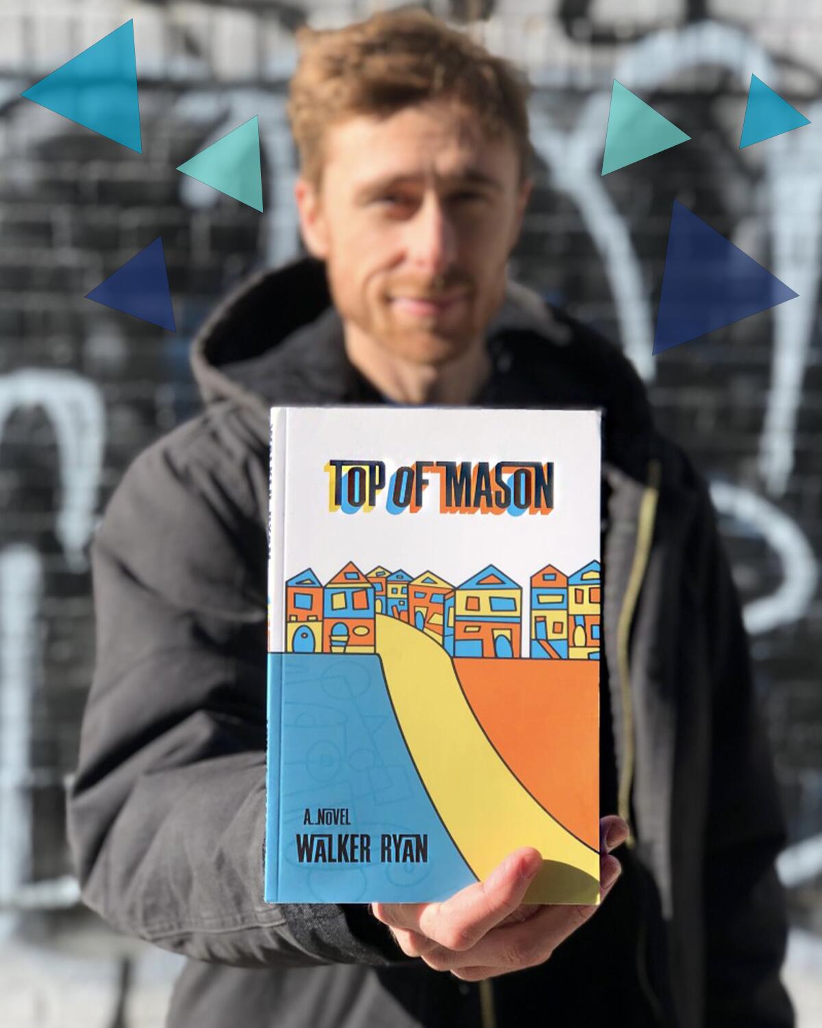 Walker Ryan holds his first novel, “Top of Mason.”