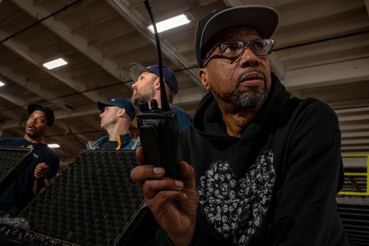 Emanuel, 56, uses a walkie-talkie during a ManifestWorks workshop