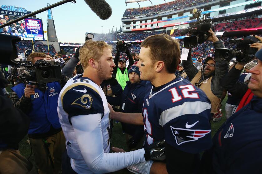 Rams quarterback Jared Goff (16) greets Patriots quarterback Tom Brady (12) after New England's 26-10 win at Gillette Stadium on Sunday.