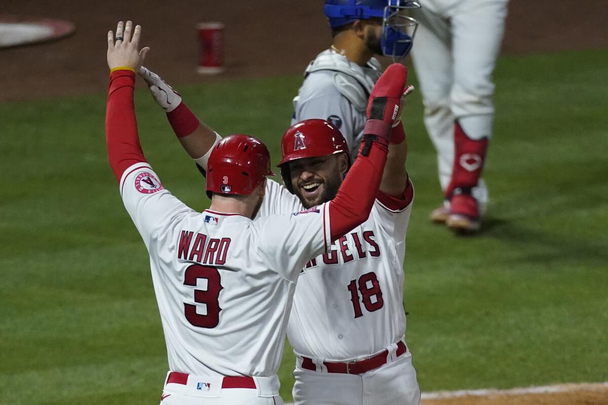 Two Angels players raise their hands to celebrate a homer