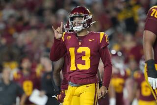 USC quarterback Caleb Williams holds up two fingers and signals to a teammate during a game against Stanford 
