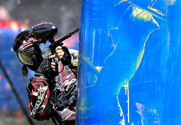 Orestas Guada of the Miami Rage aims for his opponents from behind an air bunker at the U.S. Paintball League Huntington Beach Open tournament.
