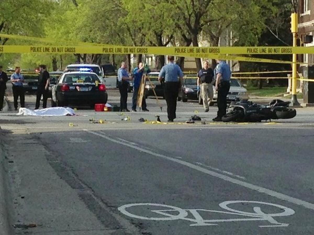 A motorcyclist died after colliding with a police squad car rushing to the scene of a shooting between a suspected burglar and police in Minneapolis.