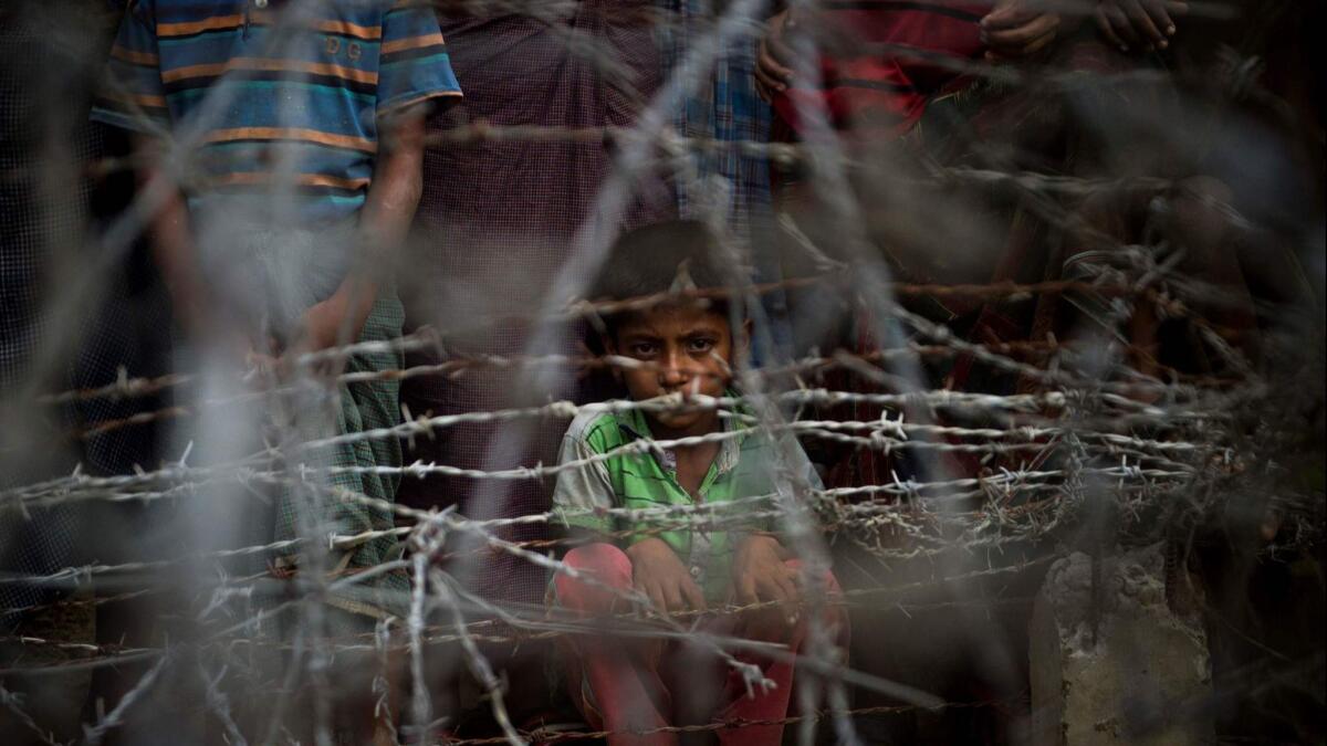 Rohingya refugees gather in the no-man's-land beyond Myanmar's border lined with barbed wire fences in Maungdaw district, Rakhine state, in April 2018.