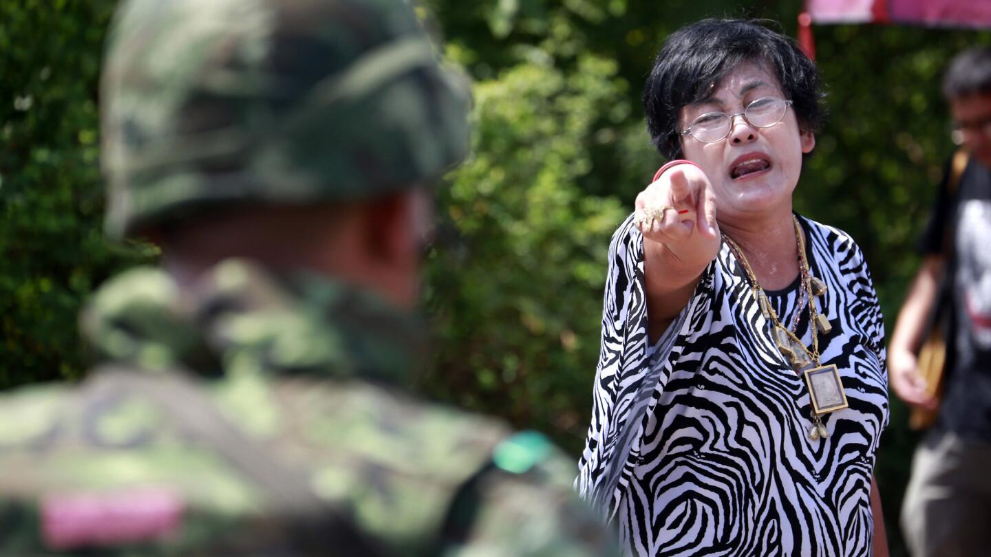 A protester points at a soldier during a cleanup of a pro-government demonstration site on the outskirts of Bangkok, Thailand, on May 23.
