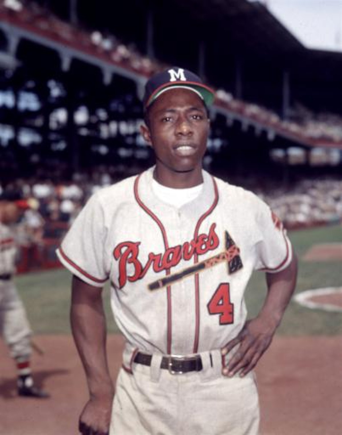 Milwaukee Braves outfielder Hank Aaron stands on the field before an exhibition game.