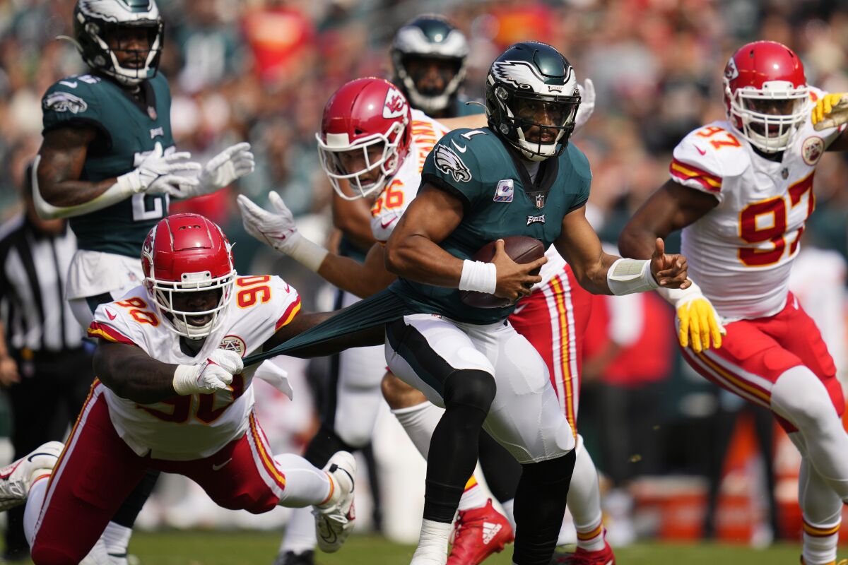 Philadelphia Eagles quarterback Jalen Hurts runs with the ball.