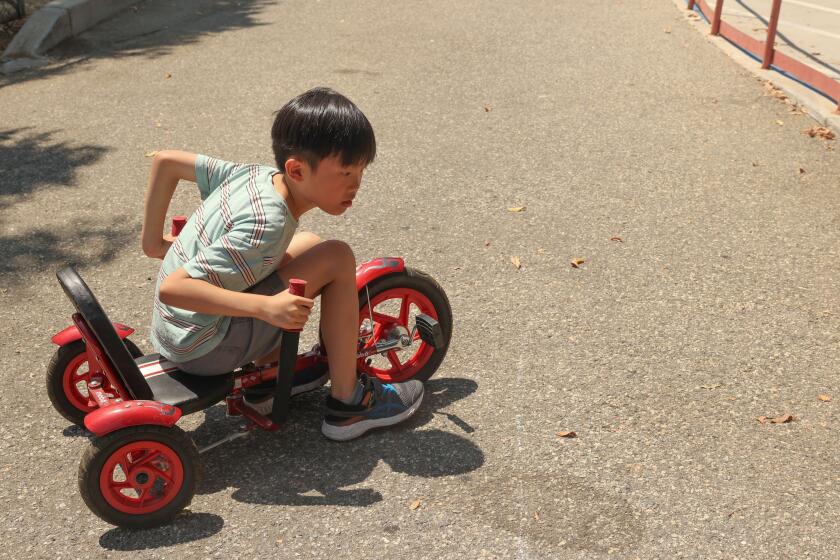 Monterey Park, CA - August 23: Alden Hong, 7, rides his mini recumbent bike at Sunnyslopes Park on Friday, Aug. 23, 2024 in Monterey Park, CA. (Michael Blackshire / Los Angeles Times)