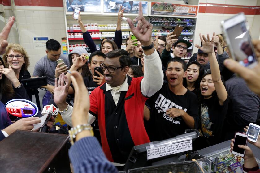 Lottery fans celebrate at the Chino Hills 7-Eleven store where one of the winning tickets in the $1.5-billion Powerball drawing was sold.