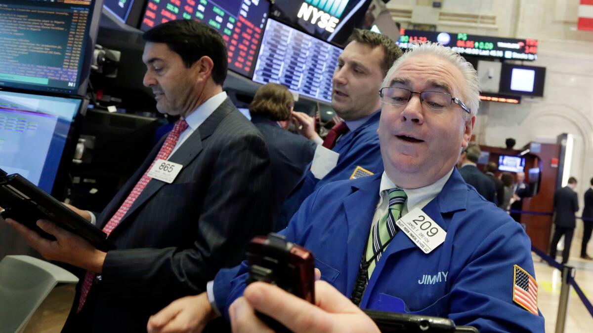 Stocks bounced back in the last hour of trading, with gains by technology companies outweighing losses in healthcare and other sectors. Above, traders work on the floor of the New York Stock Exchange.
