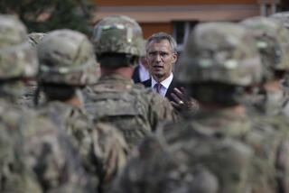 FILE - NATO Secretary General Jens Stoltenberg talks to US army soldiers while visiting Prague, Czech Republic, on Sept. 9, 2015. The Czech Republic has completed the ratification of an defense treaty with the United States that deepens military cooperation and make it easier to deploy U.S. troops on Czech territory. Czech Prime Minister Petr Fiala's signature on Wednesday Aug. 16, 2023 was the final step in the ratification process of the Defense Cooperation Agreement. (AP Photo/Petr David Josek, File)