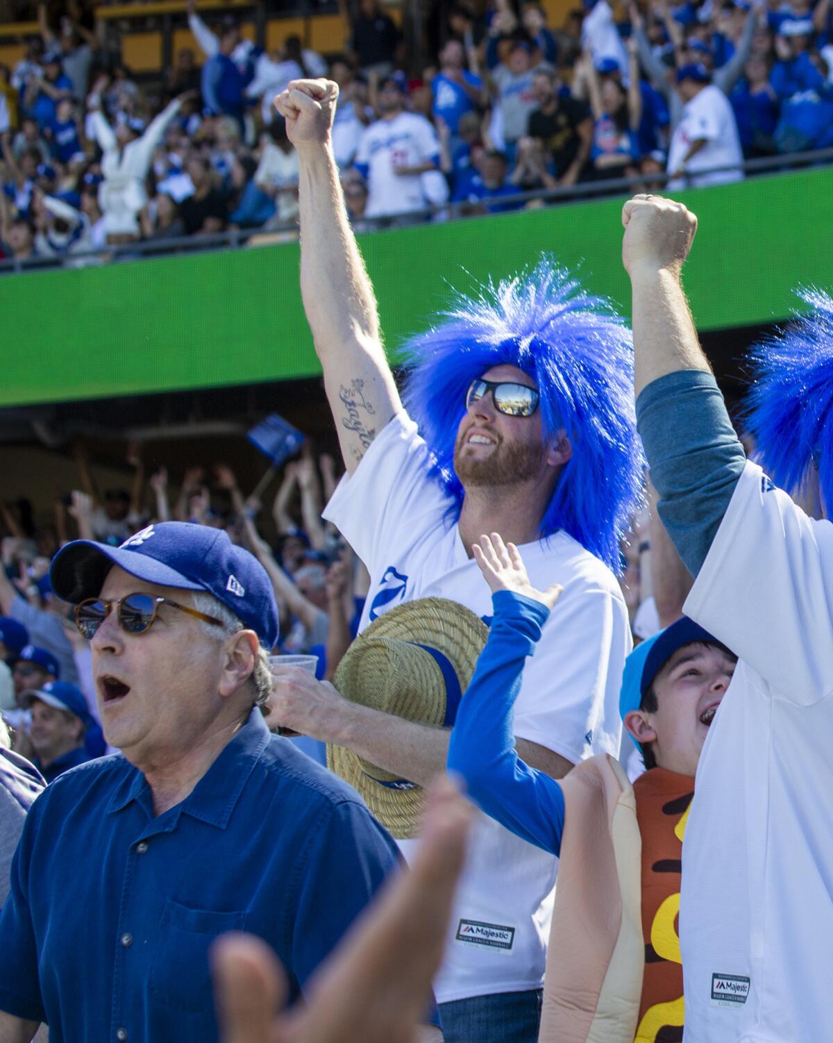 Dodgers fans celebrate Cody Bellinger’s seventh-inning home run. The Dodgers hit eight home runs, a major league record for opening day.