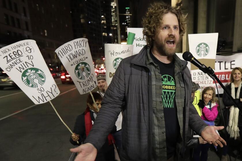 Jason Reid, director of the "Sonicsgate" documentary film, speaks during a protest outside a book-promotion event held by former Starbucks CEO Howard Schultz, Thursday, Jan. 31, 2019, in Seattle. Schultz has faced a rocky reception since he announced earlier in January that he's considering an independent presidential bid. Schultz was the former owner of the NBA basketball team, the Seattle SuperSonics, when it was sold to new owners who moved the team to Oklahoma to become the Oklahoma City Thunder. (AP Photo/Ted S. Warren)